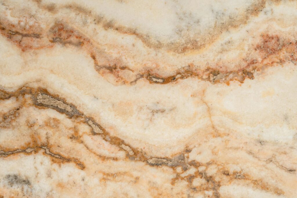 pexels-photo-7718458-7718458 Close-up view of a beige and brown marble texture showcasing natural patterns.
